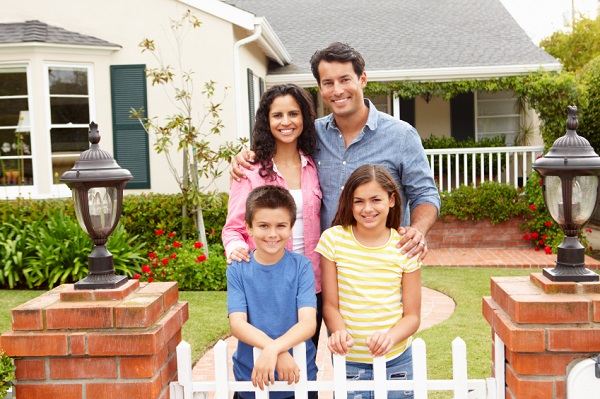 Happy Family in Front of New House