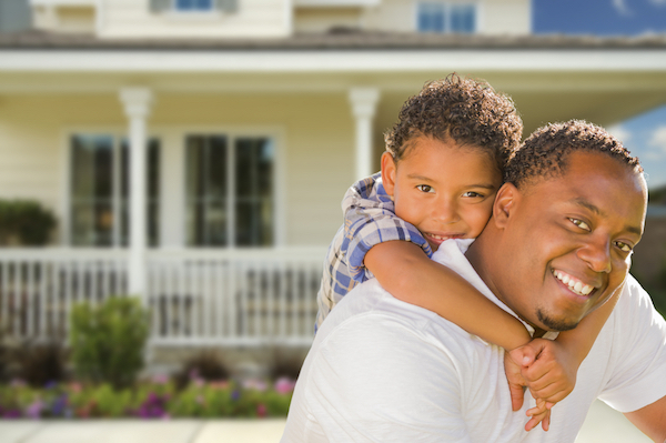 Father with son in front of home