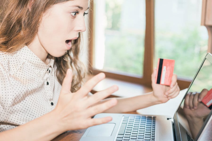 Secure Online Transactions: Woman with Credit Card and Laptop Screen