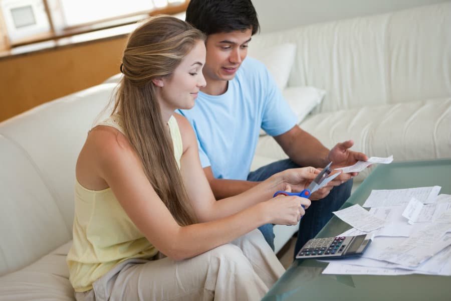 Couple Reviewing Documents and Discussing Matters on a Sofa