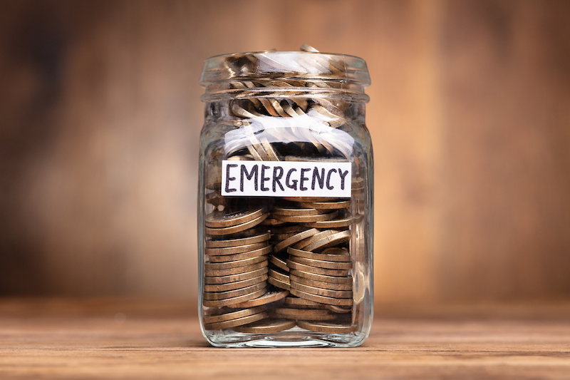 Emergency Savings Jar with Coins on Wooden Table - Building an Emergency Fund