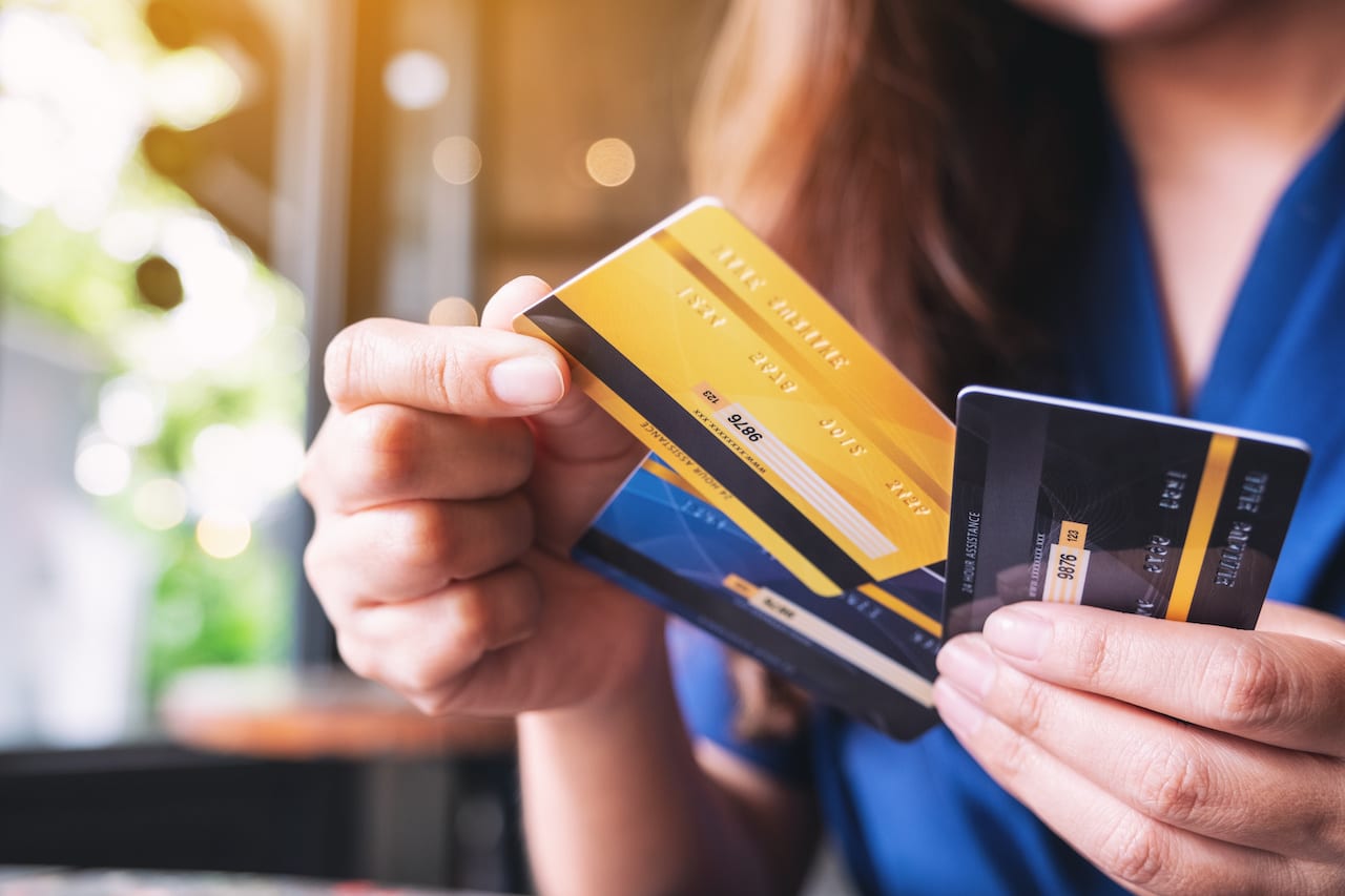 Woman Holding Two Credit Cards, Demonstrating Financial Independence