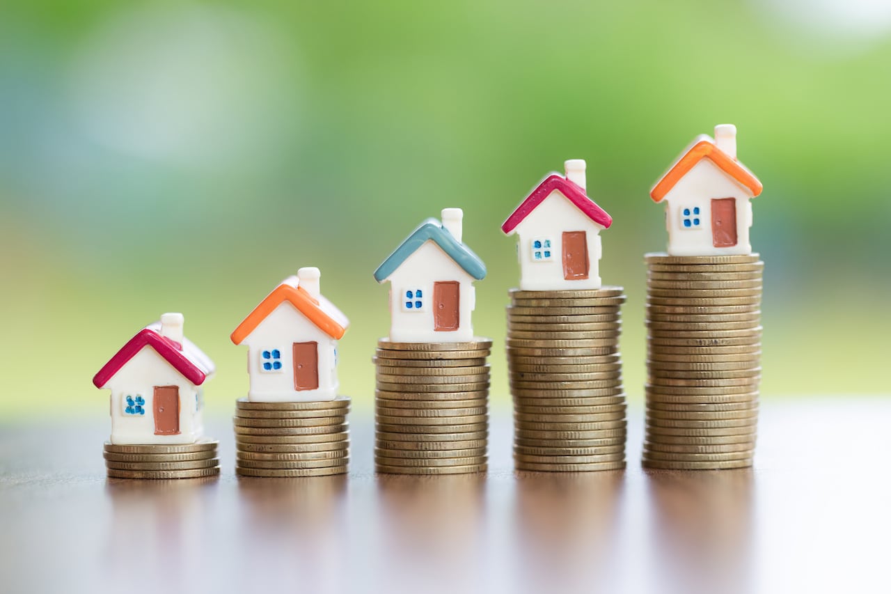 Tiny Homes Balanced on Coin Stacks