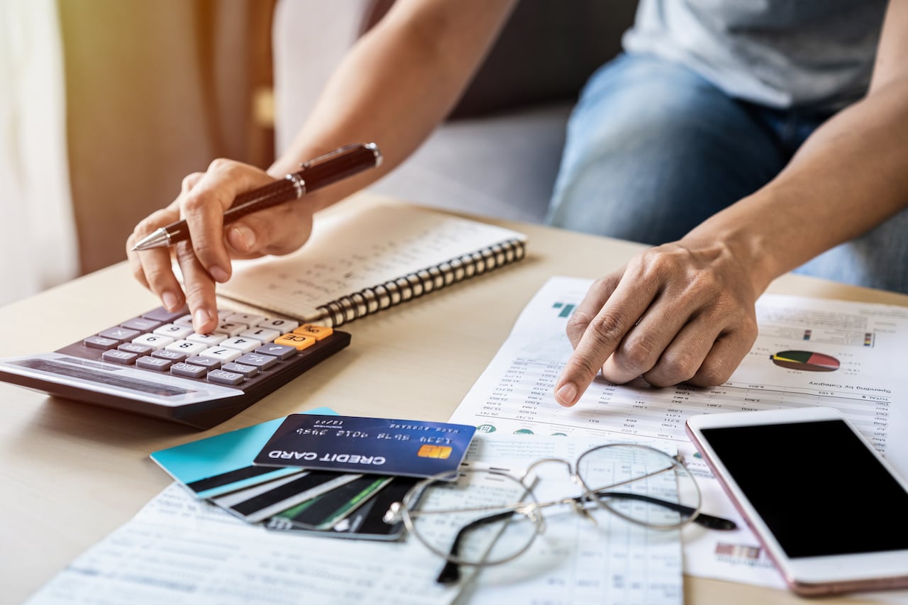 Woman managing finances with calculator