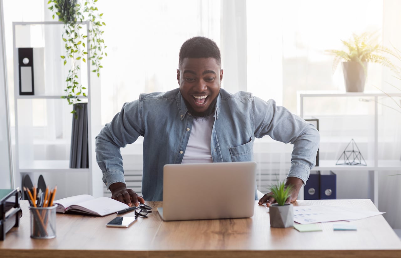 Focused Man at Desk Working on Laptop – Career Advancement and Pay Raise.