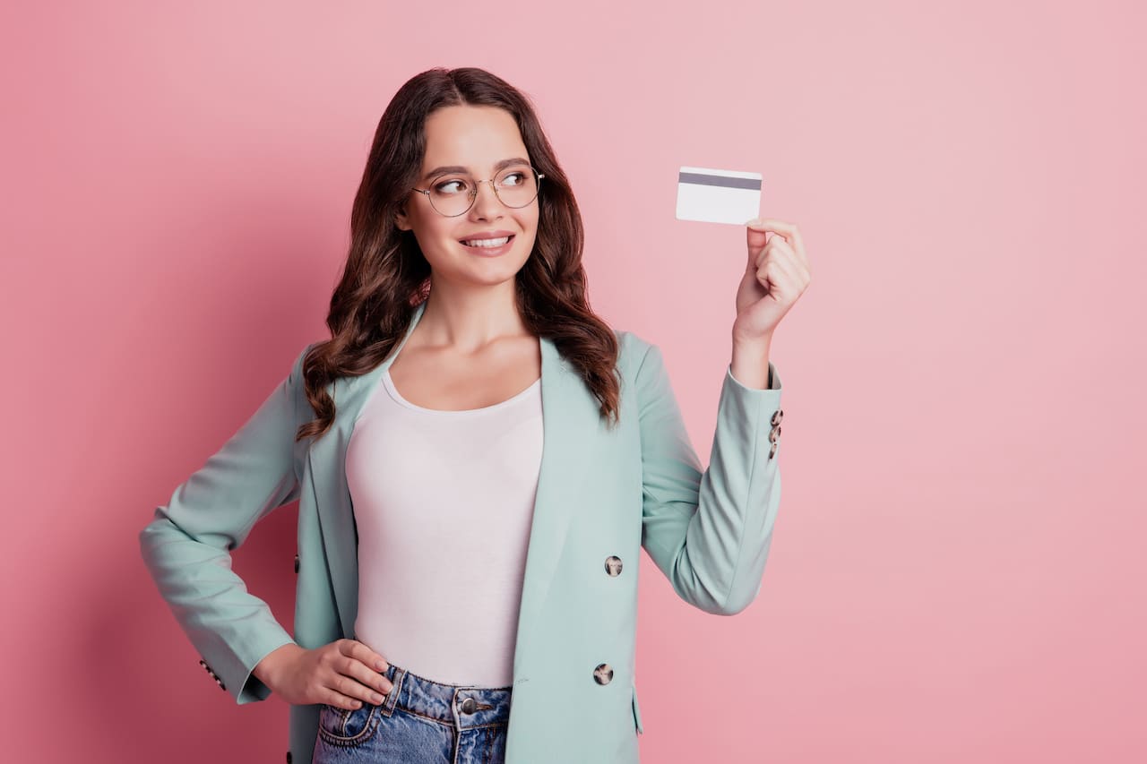 Woman Holding Credit Card - Improving Credit Card Application Success Odds
