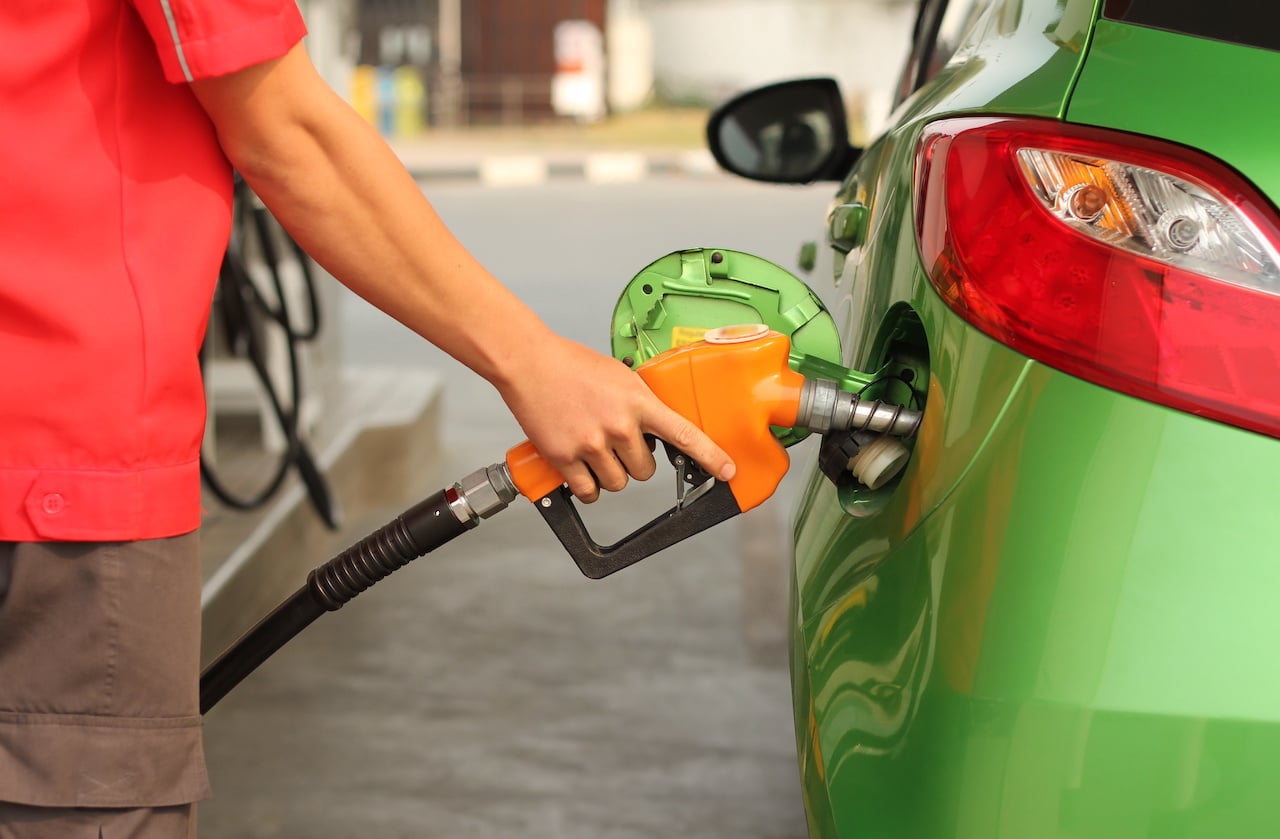 Person Refueling Green Car at Gas Station - Pre-Authorization for Credit Card Payment
