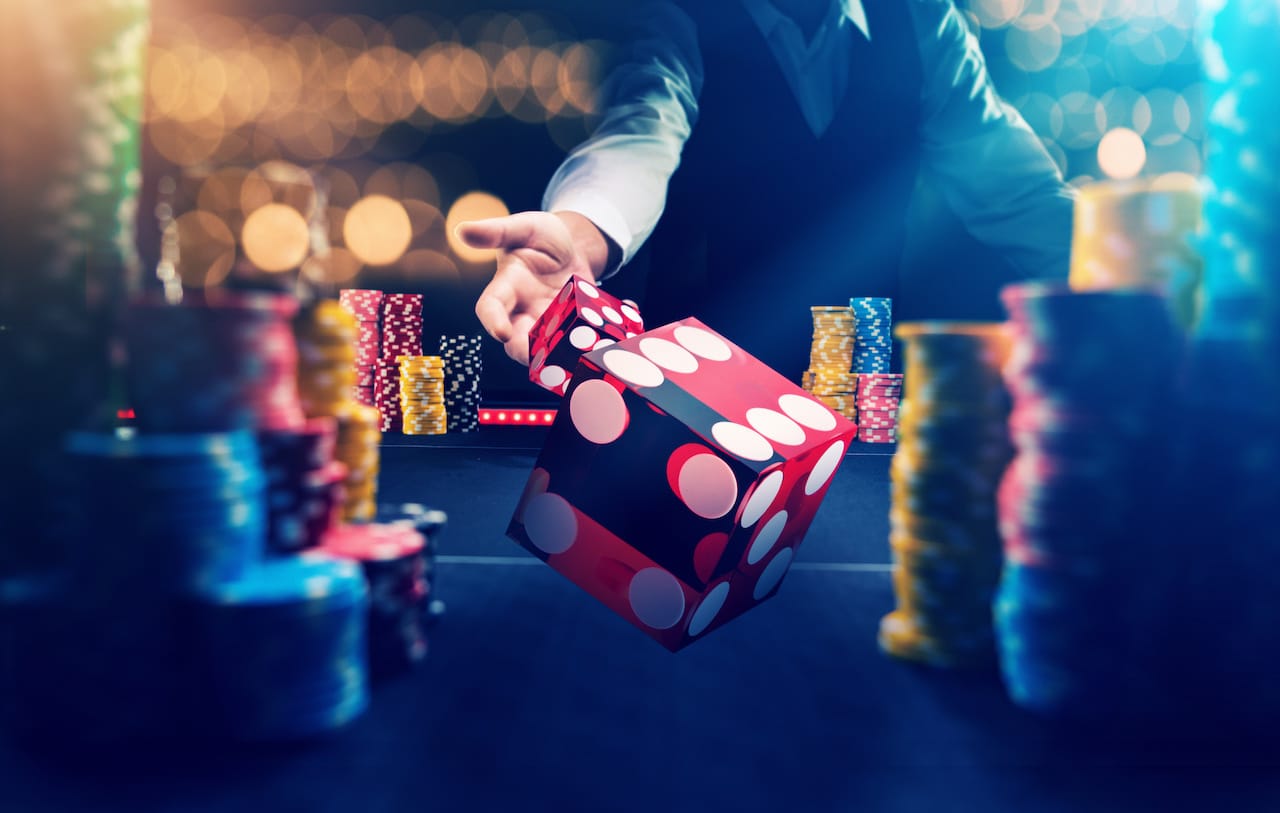 Man with Red Dice at Casino Table - Excitement and Anticipation in Gambling