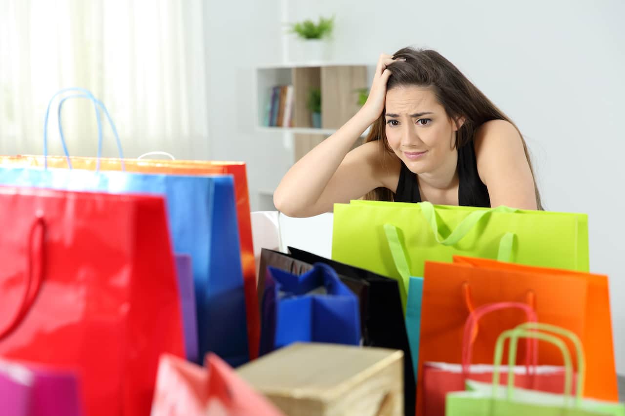 Woman with Shopping Bags Engrossed in Her Purchases