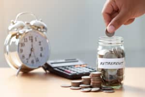 Retirement Savings Jar with Coins and Alarm Clock - Visual Reminder to Save for the Future