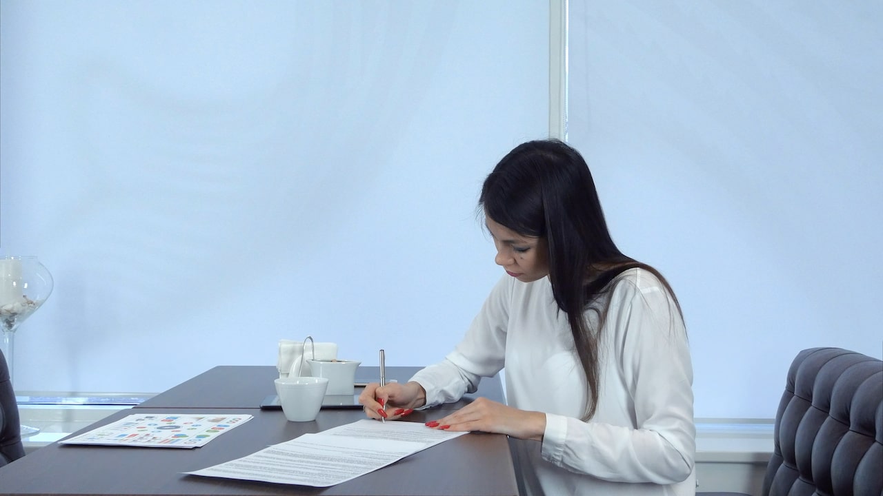 Focused Woman Managing Credit: Tackling Tasks with Papers and Pen