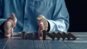 Businessman Demonstrating Financial Acumen and Wealth Management: Stacking Coins on Table