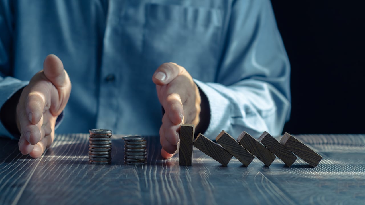 Businessman Demonstrating Financial Acumen and Wealth Management: Stacking Coins on Table