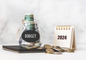 Glass Jar with Money and Calendar - 2024 Federal Budget Planning